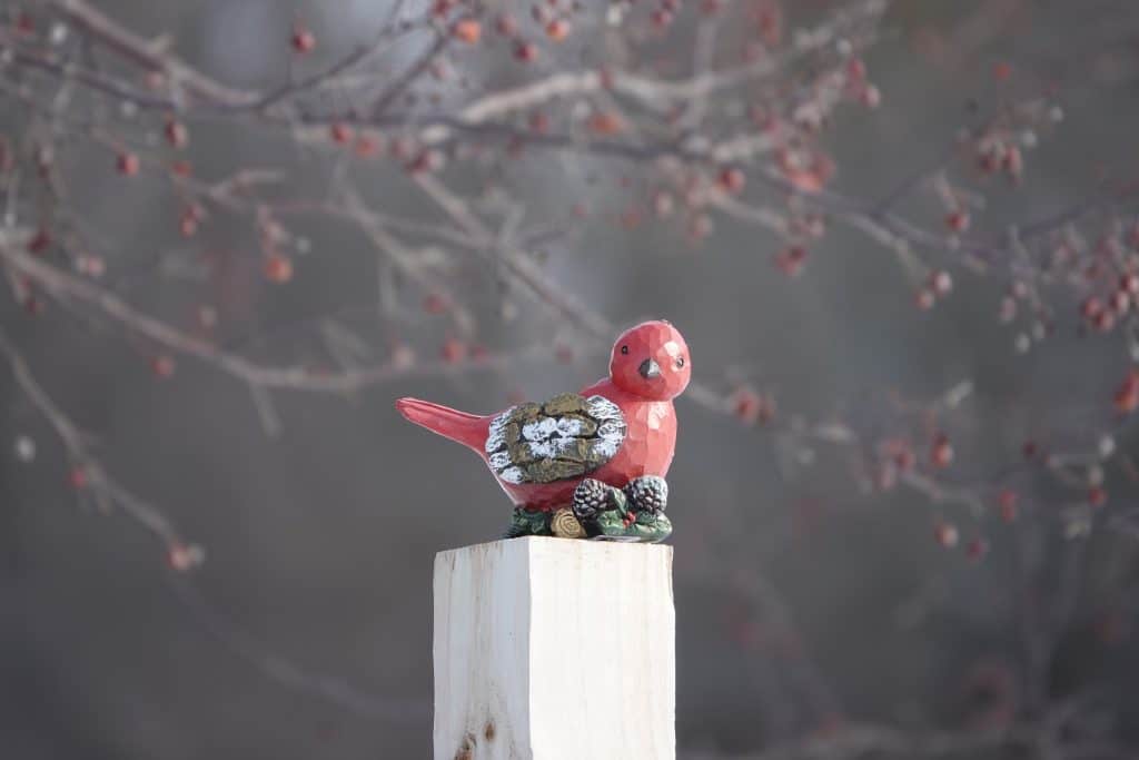 wooden cardinal on a post