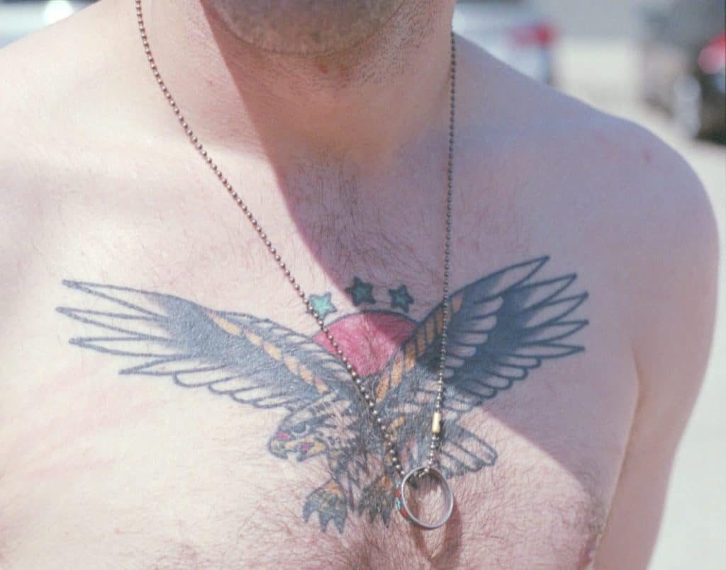 A man with an eagle tattoo on his chest