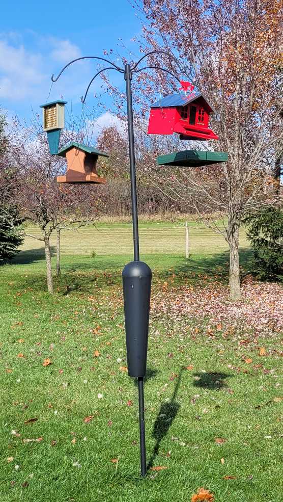 bird feeder pole with 4 feeders hanging from it