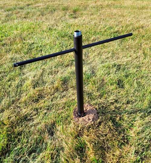 bird feeder pole being twisted into the ground